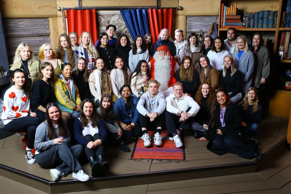 students with Santa Claus in Santa Claus Village